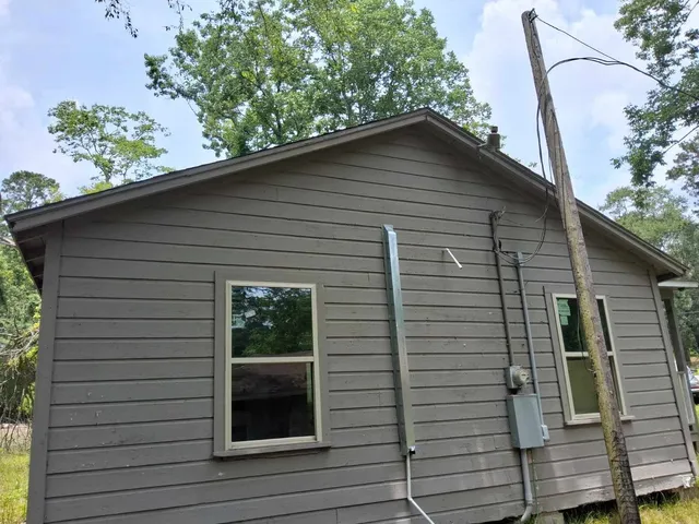 a small white building with a white roof and door