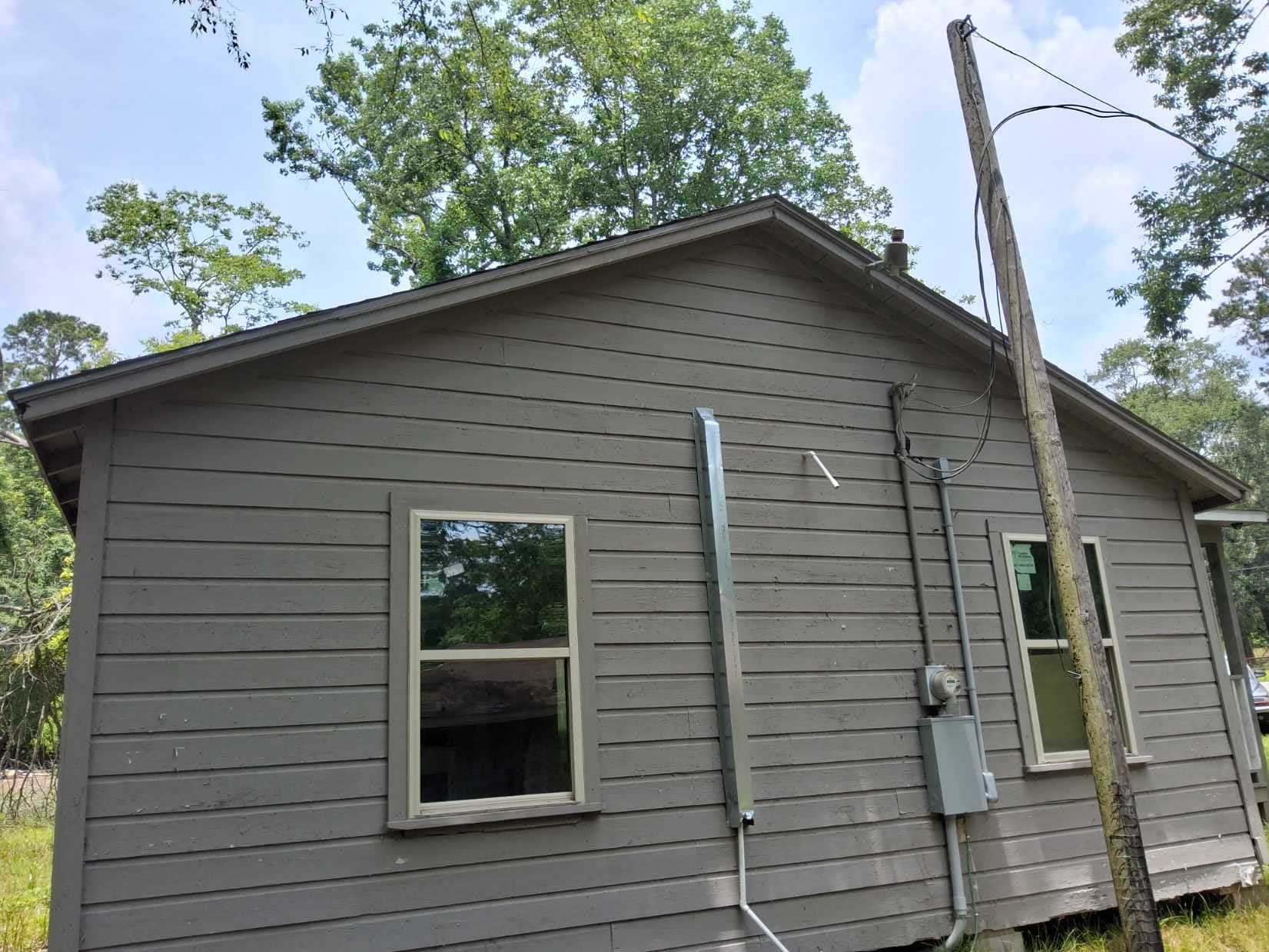 933 Shore Shadow Houston, TX 77336 - Photo 14 of 17 a small white building with a white roof and door