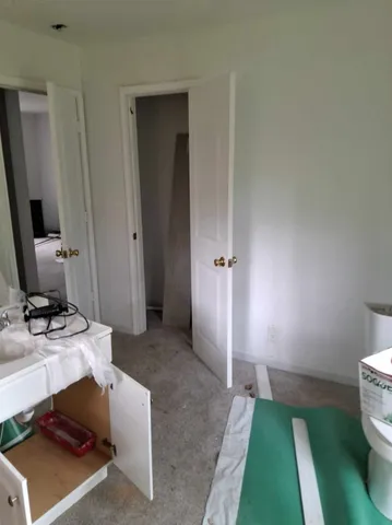 a bathroom with a sink toilet and mirror