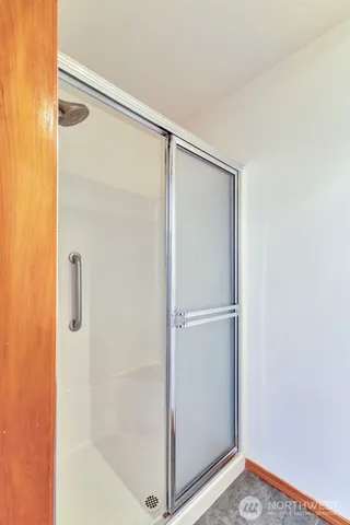 a bathroom with a glass shower door