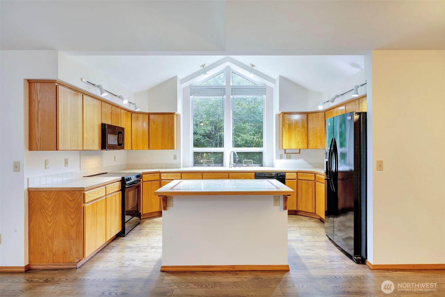 3830 Mari Lane Southeast Olympia, WA 98513 - Photo 17 of 32 a kitchen that has a sink and a stove in it