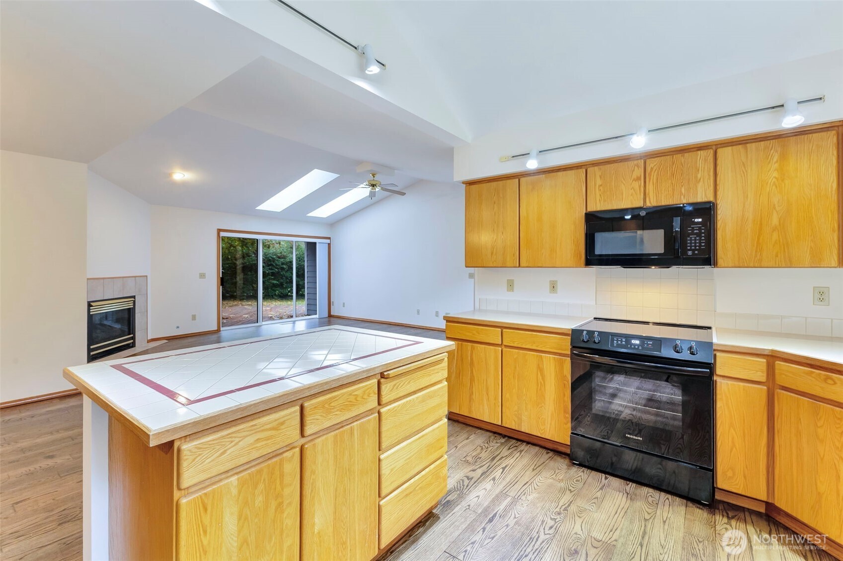 3830 Mari Lane Southeast Olympia, WA 98513 - Photo 19 of 32 a kitchen with stainless steel appliances granite countertop a sink stove and microwave