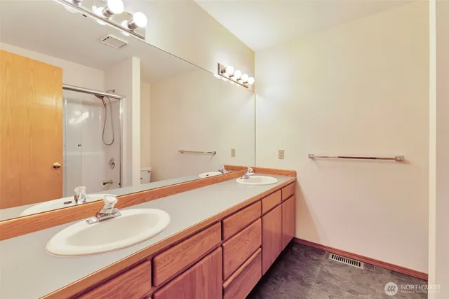 a bathroom with a glass shower door