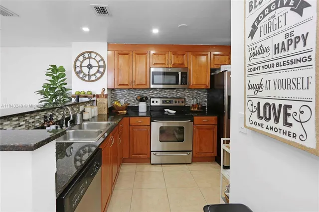 a dining room with furniture and a potted plant