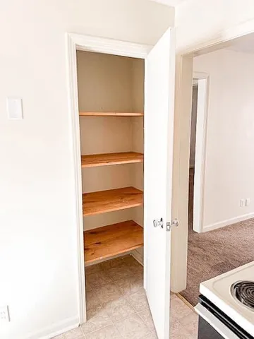 a large kitchen with stainless steel appliances granite countertop a refrigerator and a sink