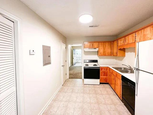 a kitchen with stainless steel appliances a refrigerator sink and stove