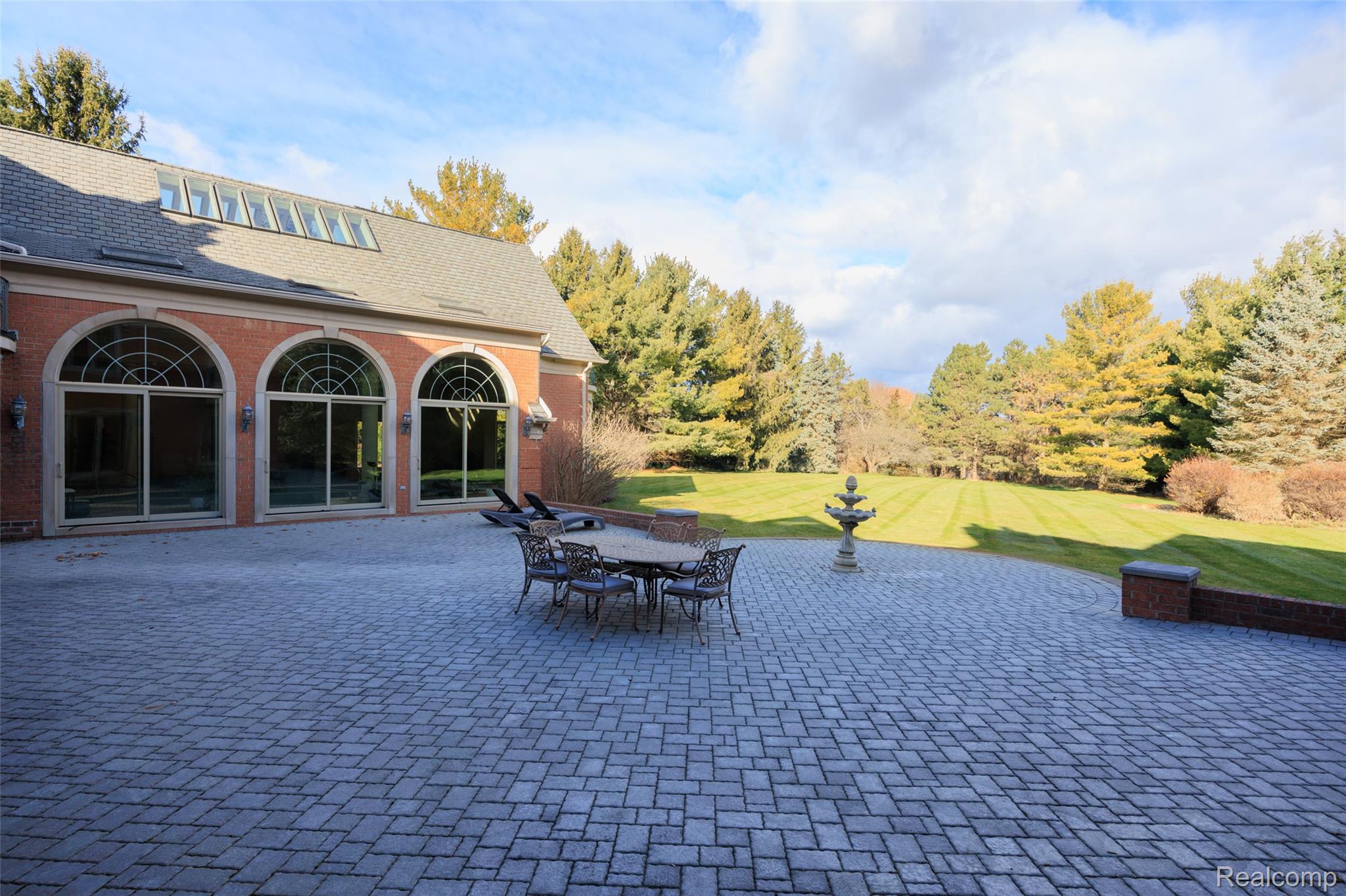 5165 Abbey Drive Rochester, MI 48306 - Photo 66 of 66 Spacious brick paver patio featuring a decorative fountain