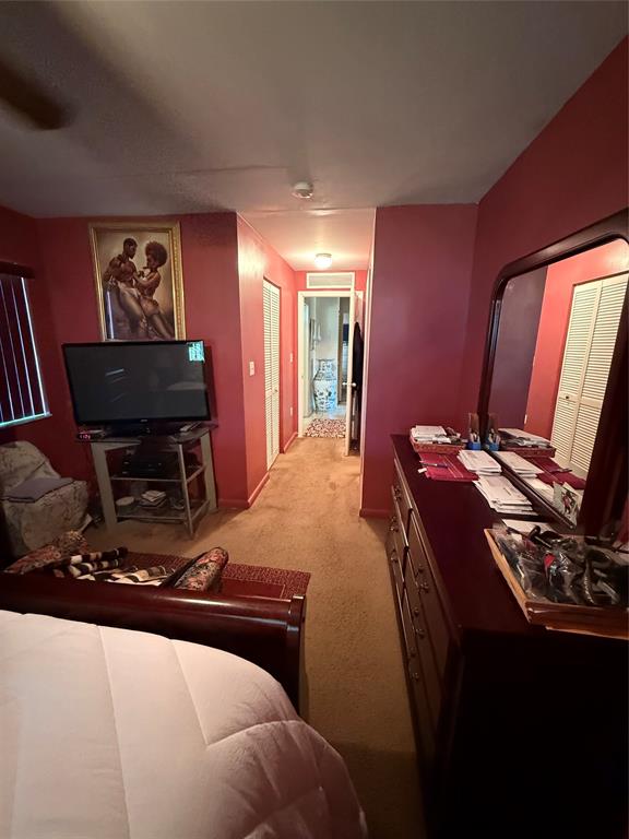 10262 Southwest 179th Street Miami, FL 33157 - Photo 12 of 26 a bedroom with a bed and a flat screen tv