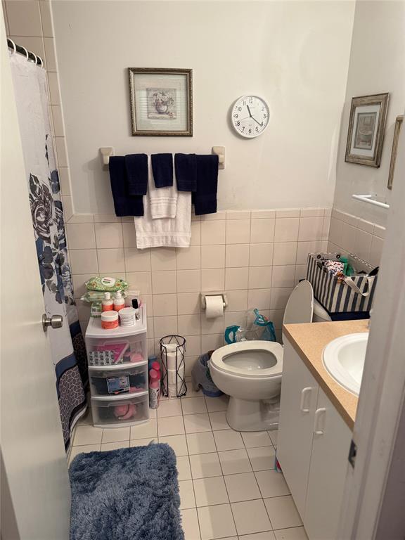 10262 Southwest 179th Street Miami, FL 33157 - Photo 13 of 26 a bathroom with a toilet a sink and a mirror