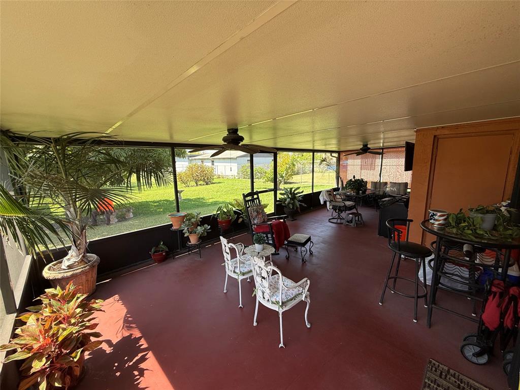 10262 Southwest 179th Street Miami, FL 33157 - Photo 9 of 26 a living room with patio furniture and potted plants