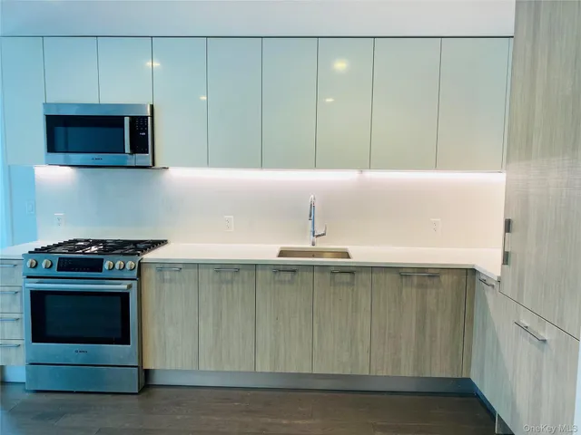 a kitchen with a sink and a stove top oven