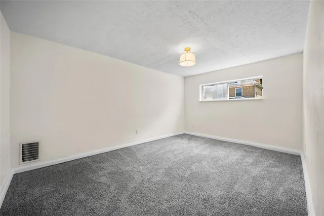 a view of an empty room and a window