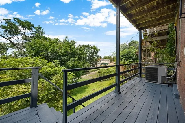 a view of a yard with plants and a building