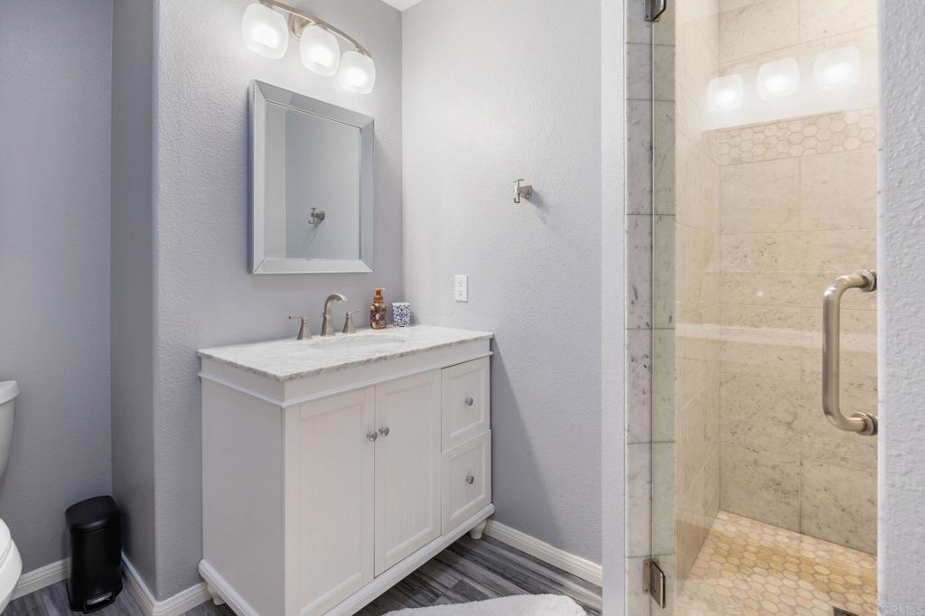 13348 Old Winery Road Poway, CA 92064 - Photo 44 of 68 a bathroom with a sink a toilet and shower