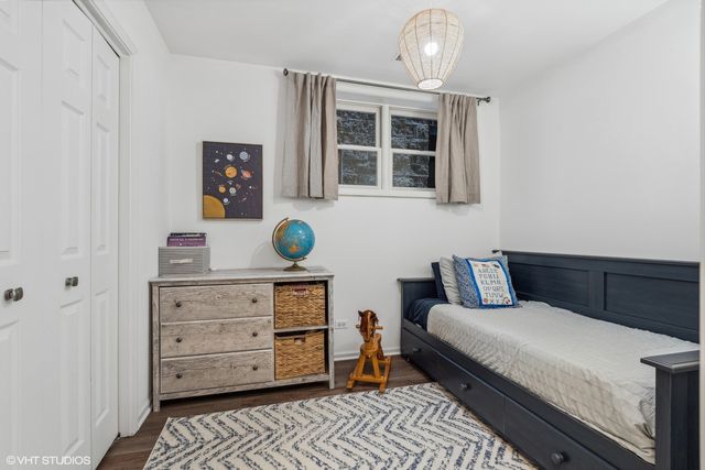 a bedroom with a bed and cabinet