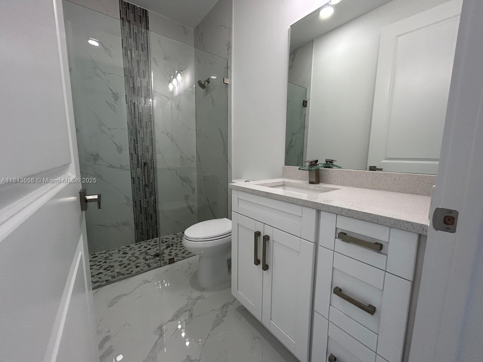 2516 Park Road, Unit 2516 Lehigh Acres, FL 33971 - Photo 13 of 13 a bathroom with a sink a toilet and shower