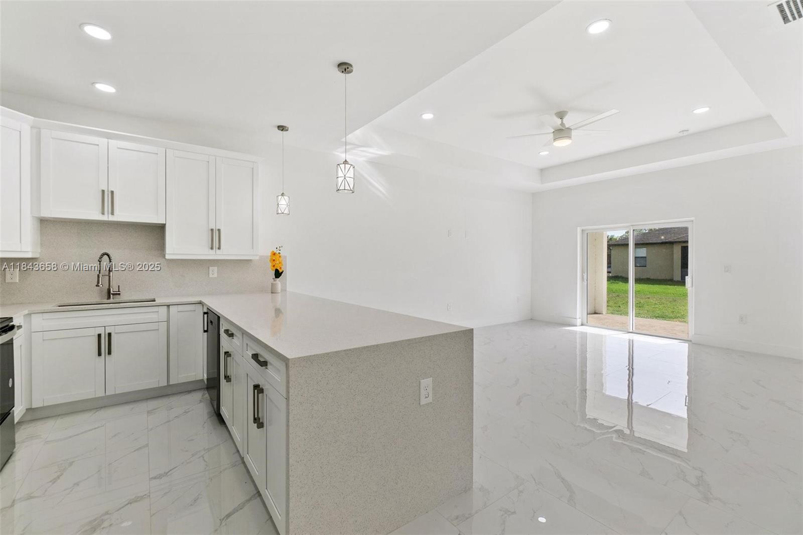 2516 Park Road, Unit 2516 Lehigh Acres, FL 33971 - Photo 6 of 13 a kitchen with a sink stove and cabinets