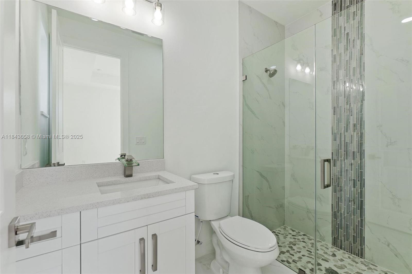 2516 Park Road, Unit 2516 Lehigh Acres, FL 33971 - Photo 9 of 13 a bathroom with a granite countertop sink a toilet and shower