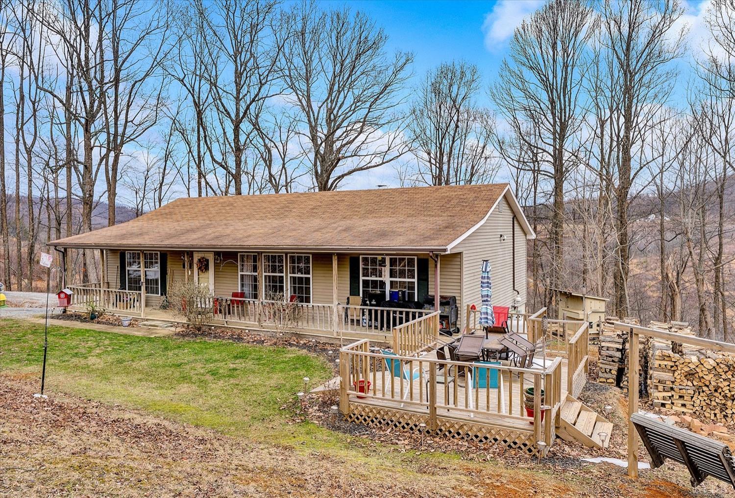 a view of a house with a yard patio and fire pit