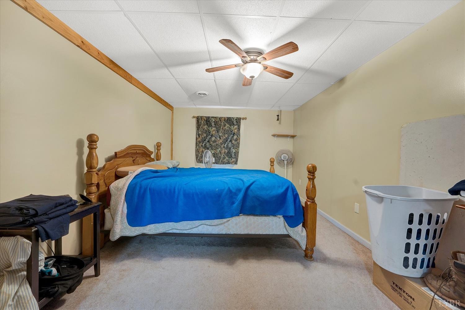 1408 Woodridge Road Blue Ridge, VA 24064 - Photo 29 of 39 a bedroom with bed and a chandelier