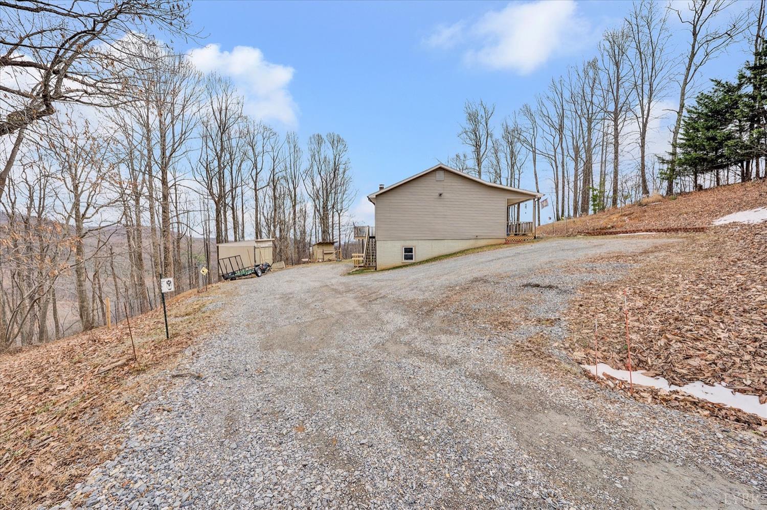 1408 Woodridge Road Blue Ridge, VA 24064 - Photo 34 of 39 a view of a house with a yard covered in snow