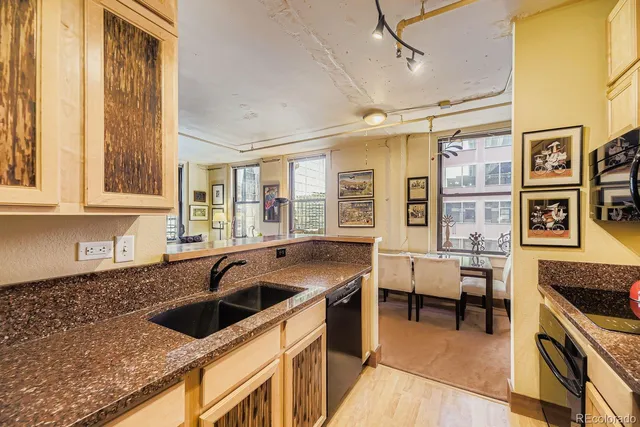 a kitchen that has a sink and chairs