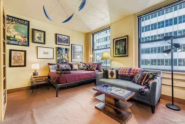 a living room with furniture and a book shelf