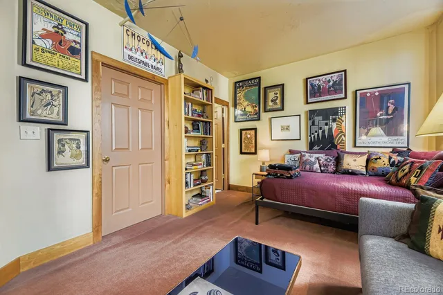 a bedroom with furniture and baby crib