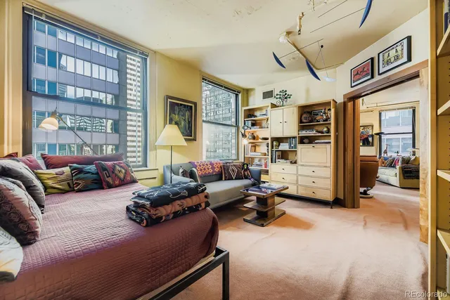 a bedroom with furniture and a large window