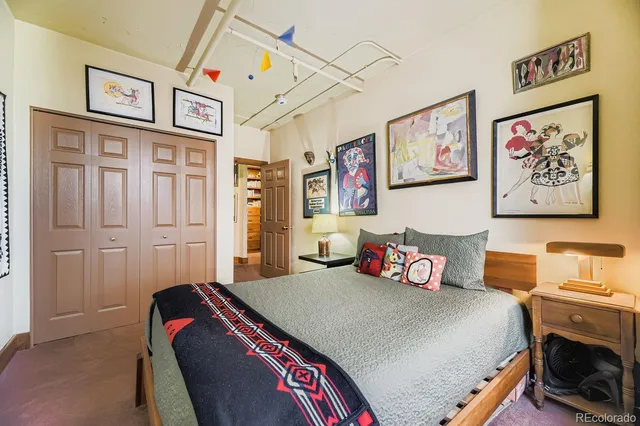 a bedroom with bed and wall painting