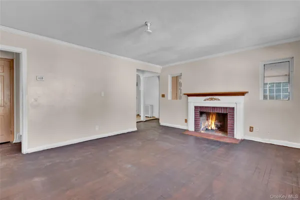 a view of empty room with a fireplace