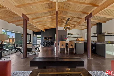 a view of living room with a table and chairs