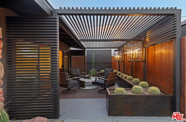 a view of a house with swimming pool and sitting area