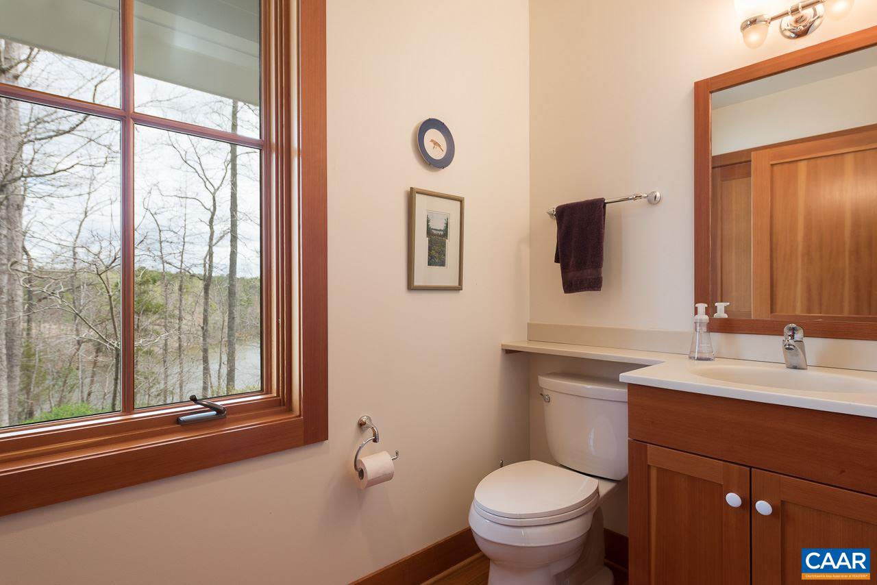 80 Ruritan Ridge Lane Scottsville, VA 24590 - Photo 25 of 37 First floor powder room with custom vanity and mirror, plus a large bonus closet.