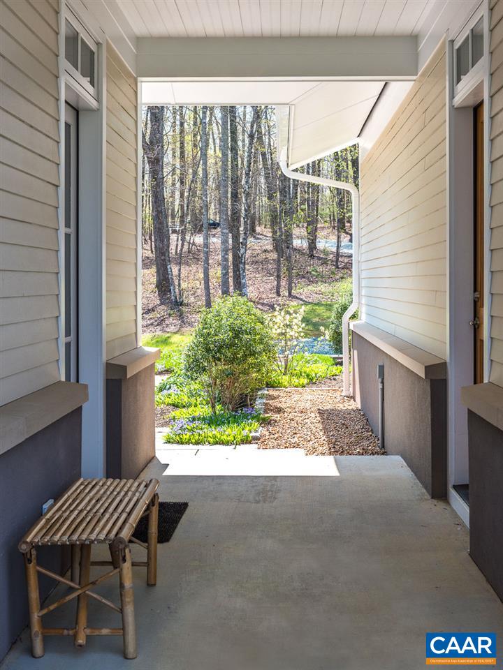 80 Ruritan Ridge Lane Scottsville, VA 24590 - Photo 6 of 37 The covered breezeway connects garage to mudroom side entry and stone patio.