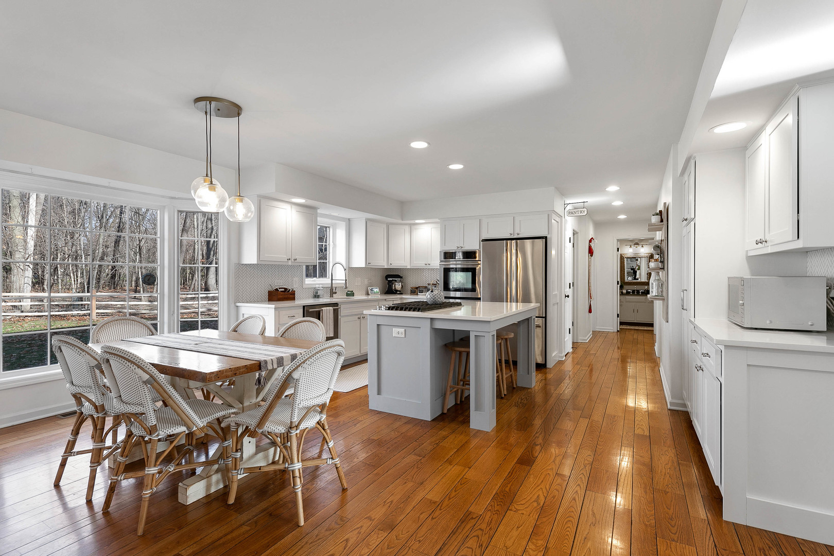 675 East Gartner Road Naperville, IL 60540 - Photo 8 of 31 a kitchen with a dining table chairs stainless steel appliances and cabinets