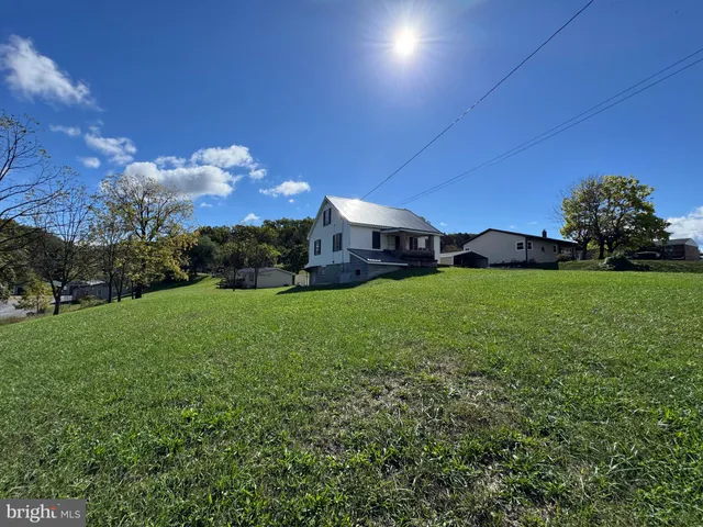 a view of a yard with a house in the background