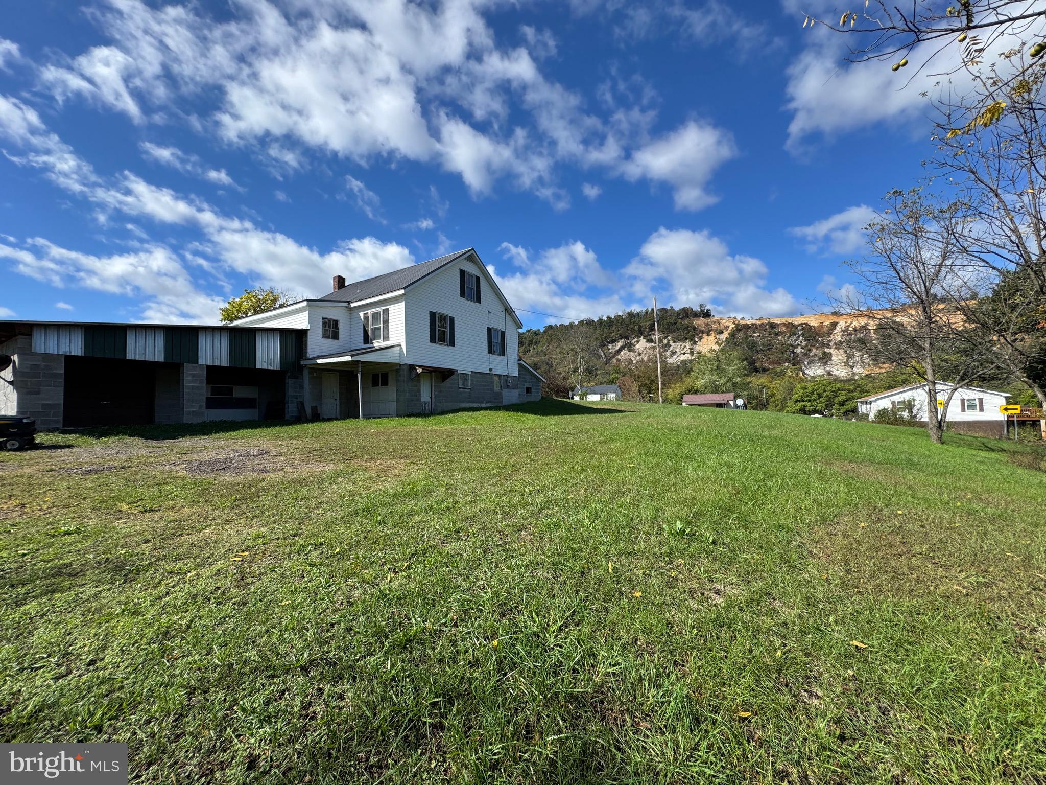 830 Harrison Avenue Berkeley Springs, WV 25411 - Photo 11 of 41 a front view of a house with a yard