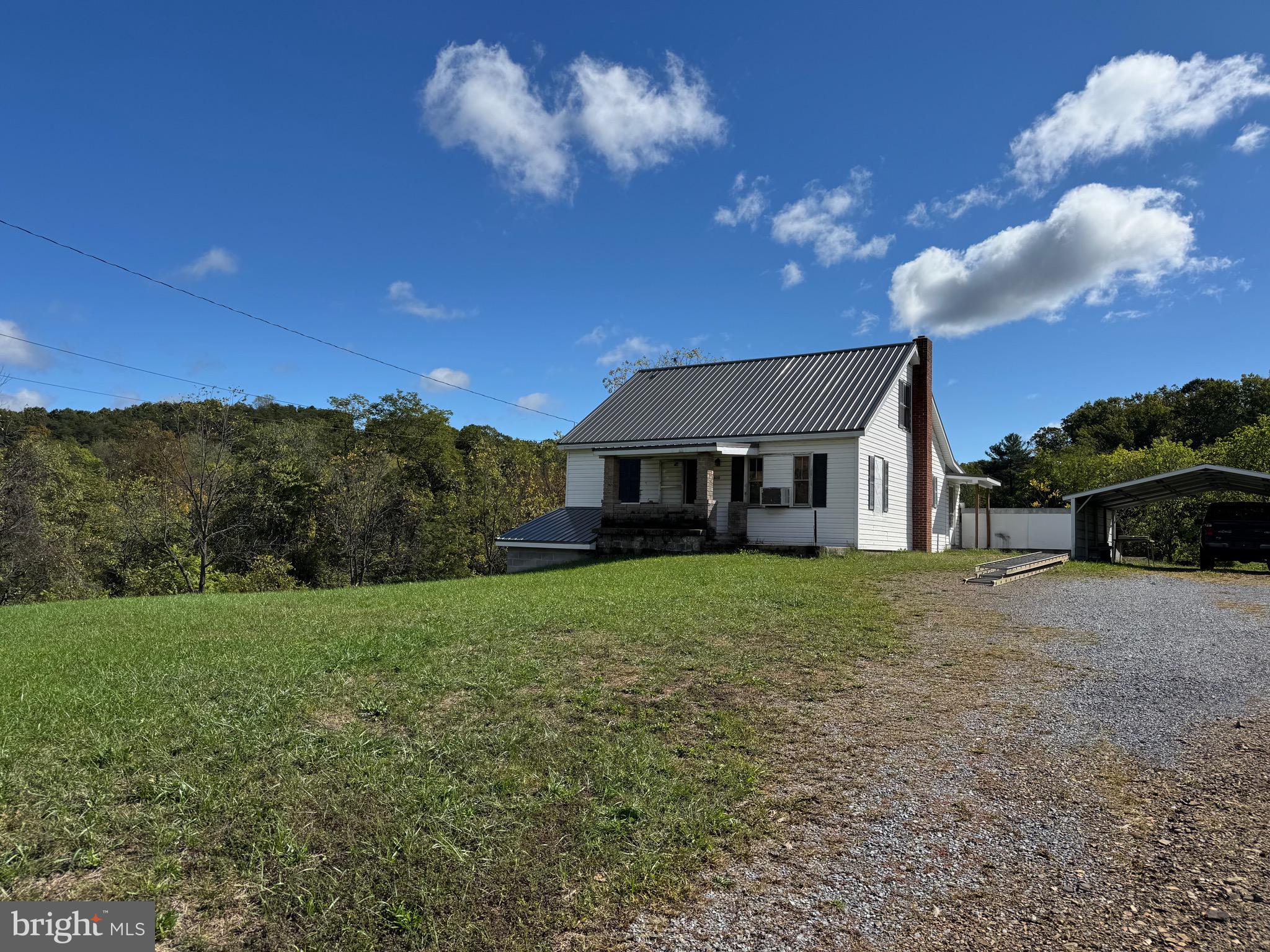 830 Harrison Avenue Berkeley Springs, WV 25411 - Photo 14 of 41 a front view of a house with a yard
