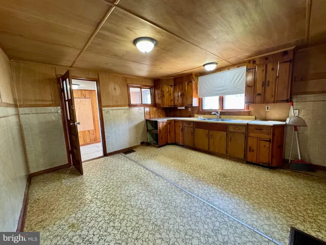 a view of a refrigerator in kitchen and utility room