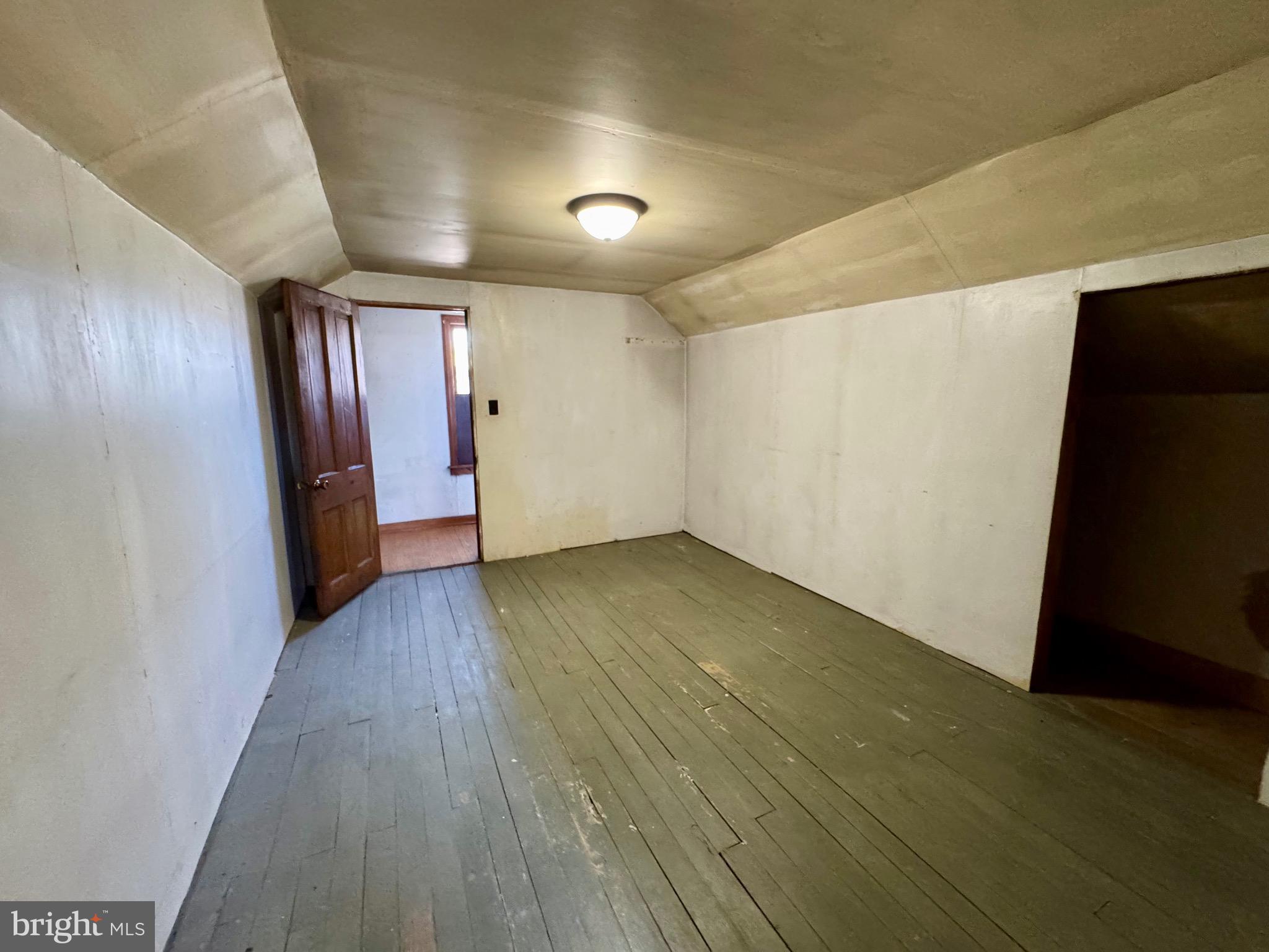 830 Harrison Avenue Berkeley Springs, WV 25411 - Photo 28 of 41 an empty room with wooden floor and windows