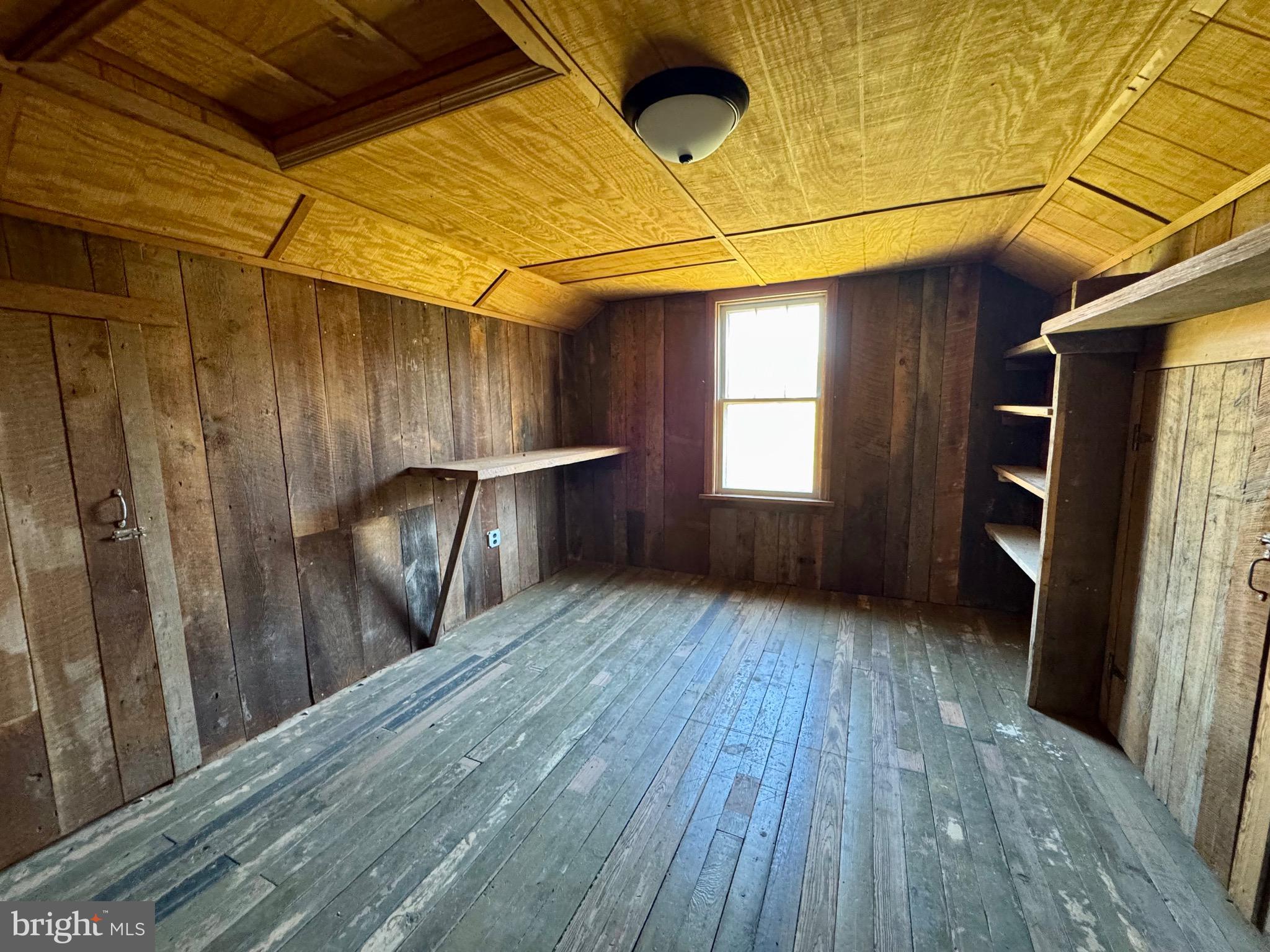 830 Harrison Avenue Berkeley Springs, WV 25411 - Photo 30 of 41 a view of a room with wooden floor and a window