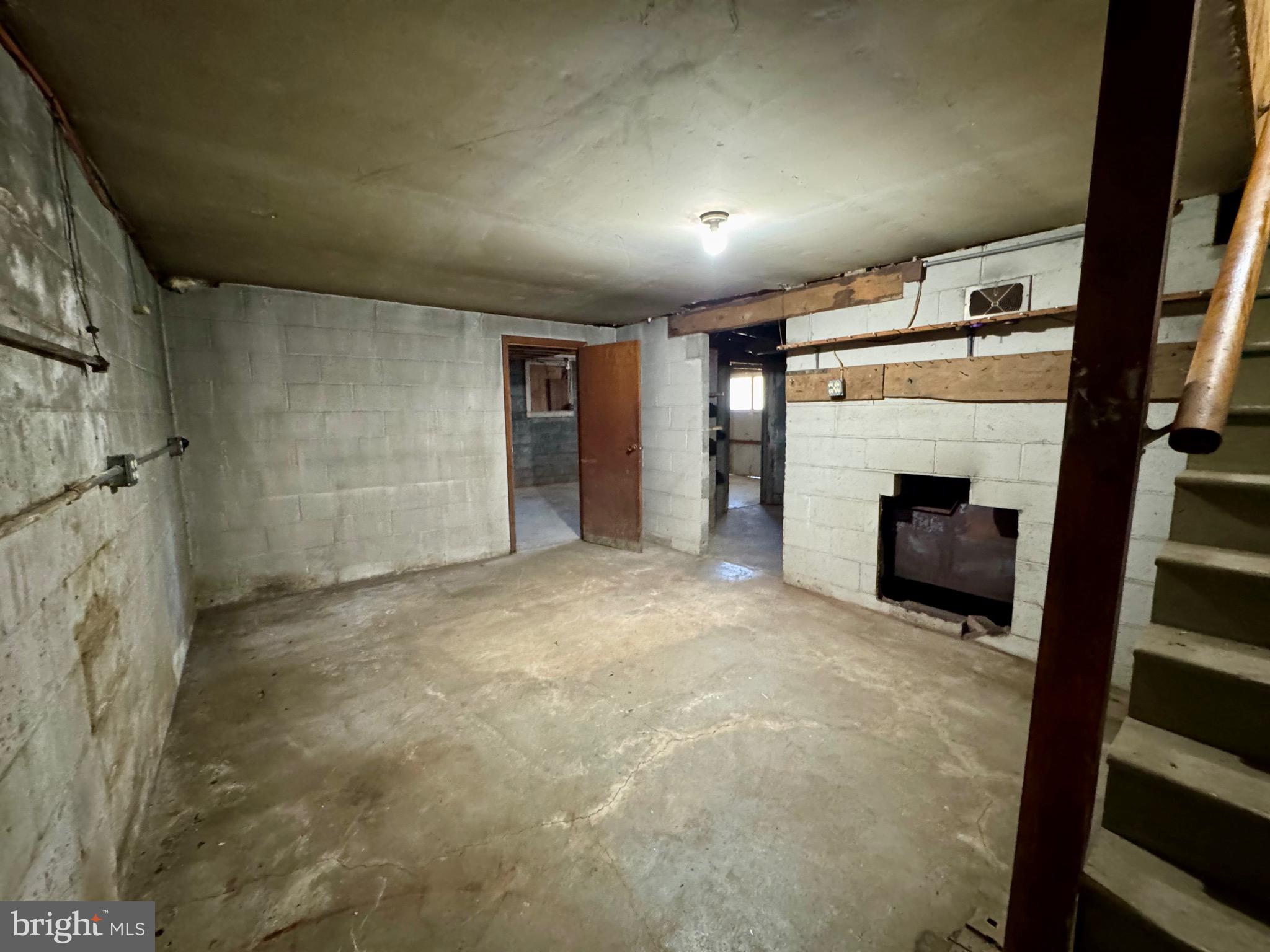 830 Harrison Avenue Berkeley Springs, WV 25411 - Photo 33 of 41 a view of empty room with a fireplace