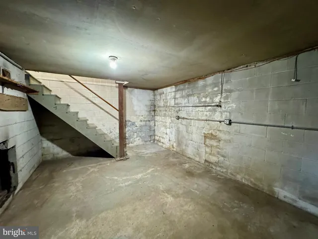 a living room with furniture and a mirror