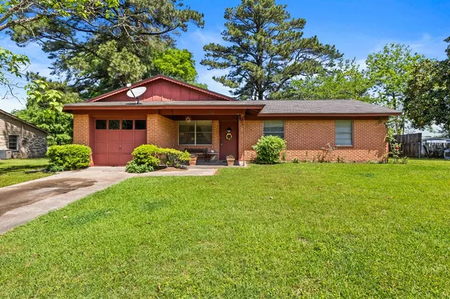 a front view of house with yard and green space