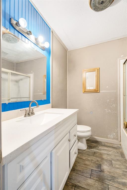 970 Mansfield Road Reno, TX 75462 - Photo 11 of 20 a bathroom with a sink a toilet and a mirror