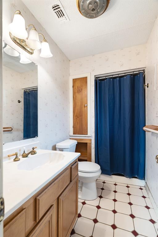 970 Mansfield Road Reno, TX 75462 - Photo 14 of 20 a bathroom with a sink a toilet and mirror