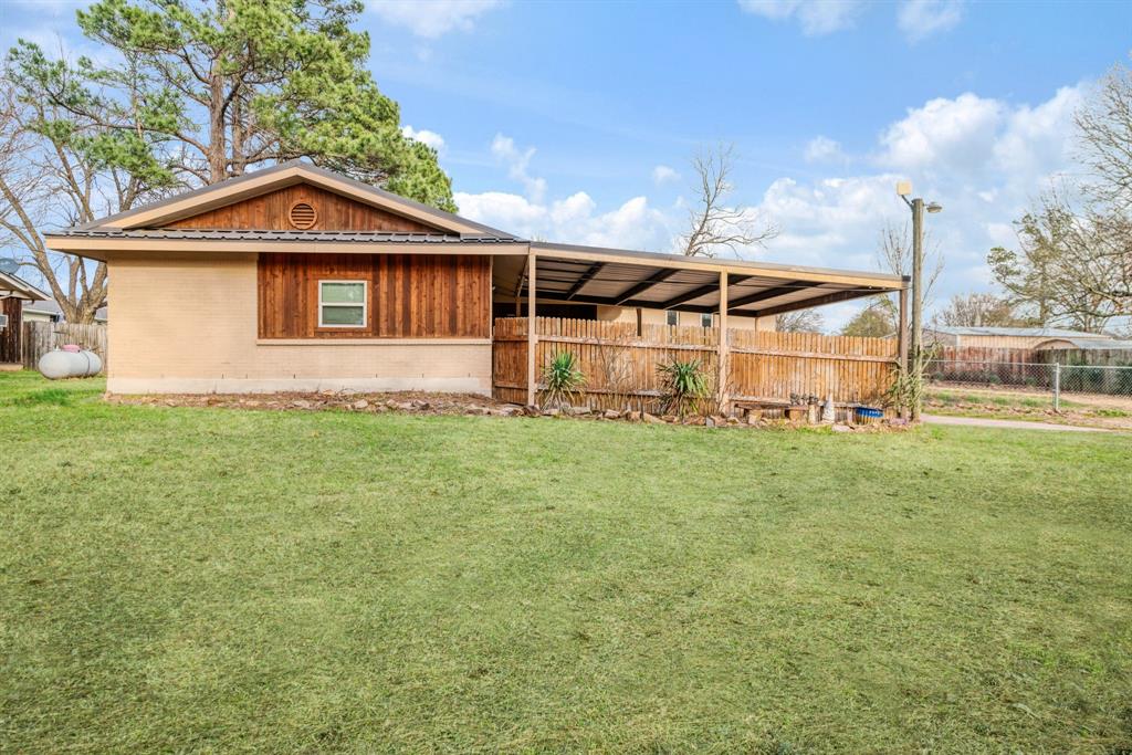970 Mansfield Road Reno, TX 75462 - Photo 2 of 20 a view of a wooden house with a yard