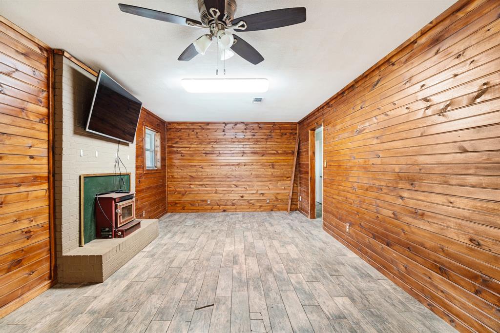 970 Mansfield Road Reno, TX 75462 - Photo 6 of 20 a view of empty room with wooden floor and fan