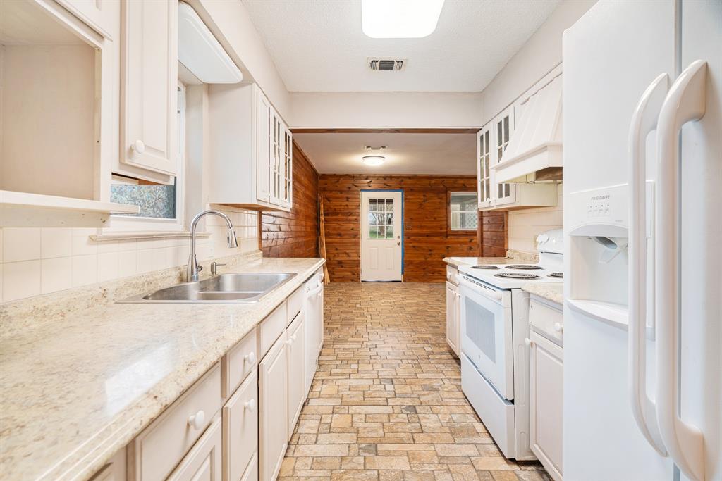 970 Mansfield Road Reno, TX 75462 - Photo 9 of 20 a large kitchen with granite countertop a sink and cabinets
